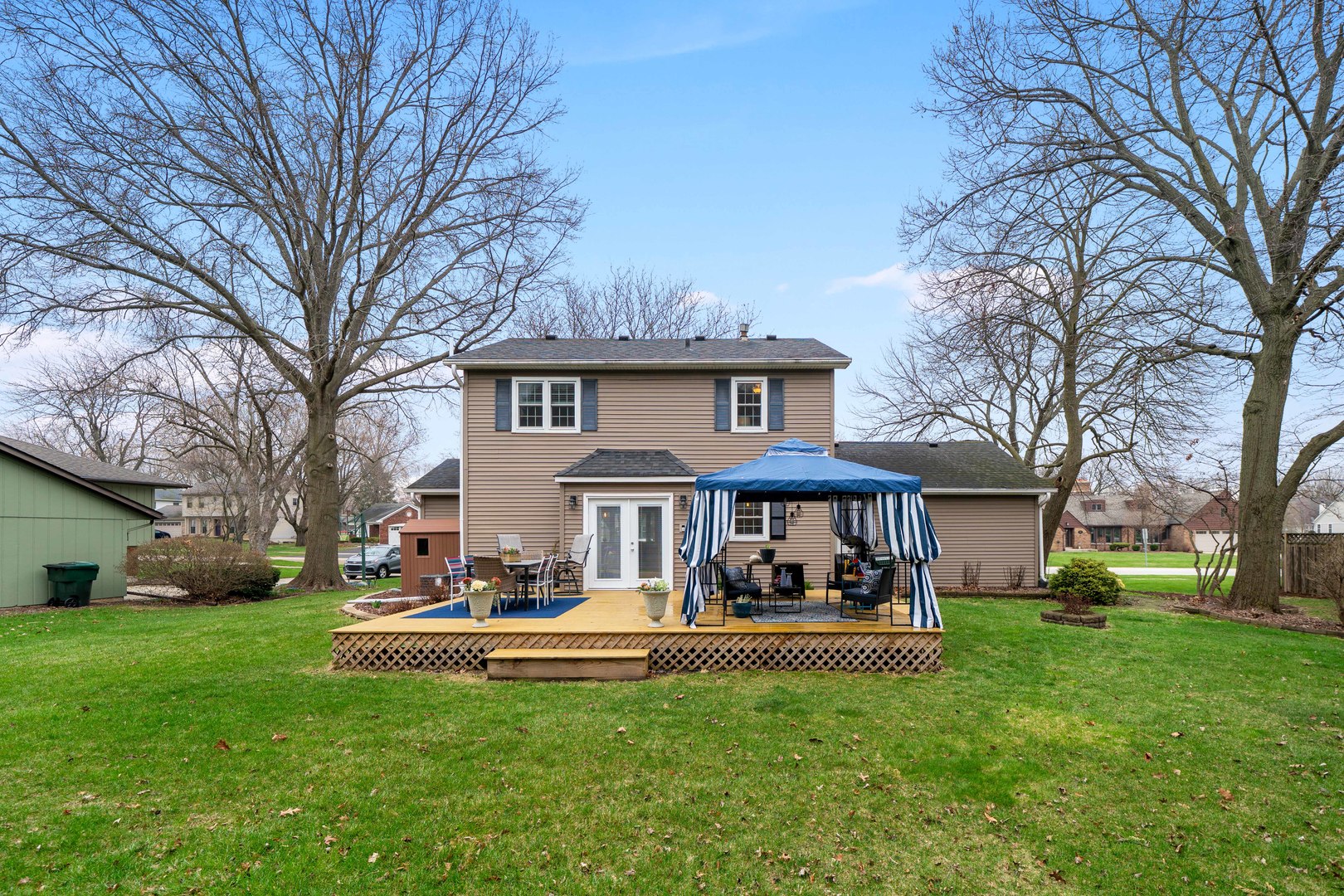 66 Winthrop New Road Sugar Grove, IL 60554 - Photo 31 of 39 a view of a white house with a big yard and large trees