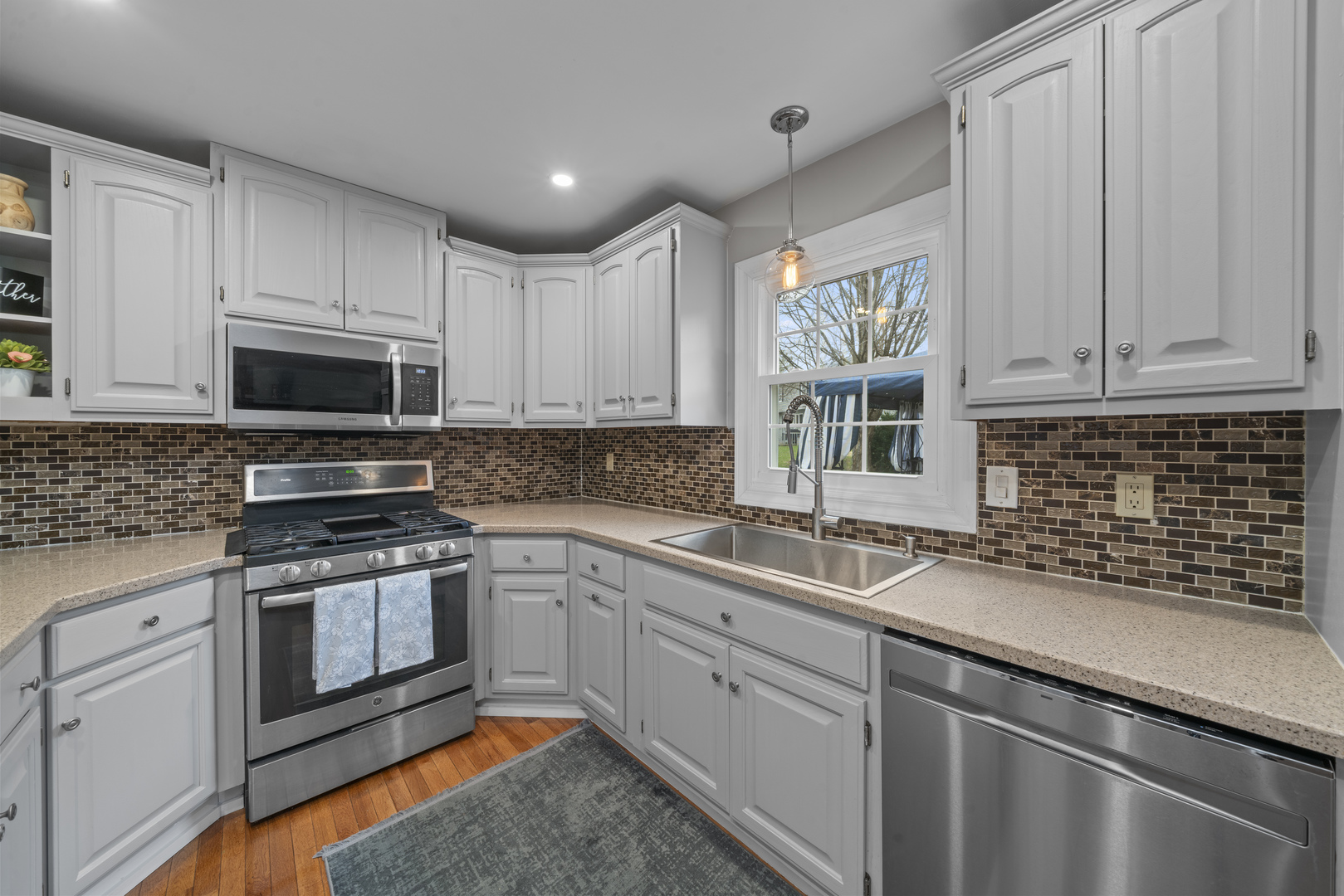 66 Winthrop New Road Sugar Grove, IL 60554 - Photo 5 of 39 a kitchen with a sink stove and microwave