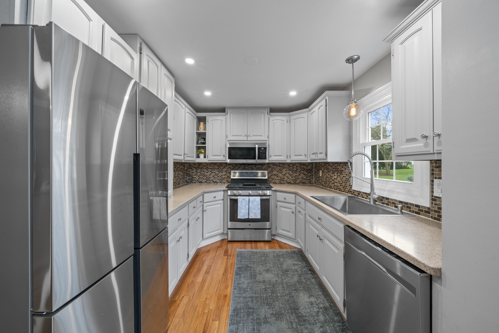 66 Winthrop New Road Sugar Grove, IL 60554 - Photo 6 of 39 a kitchen with stainless steel appliances granite countertop a refrigerator a sink dishwasher a stove and white cabinets with wooden floor