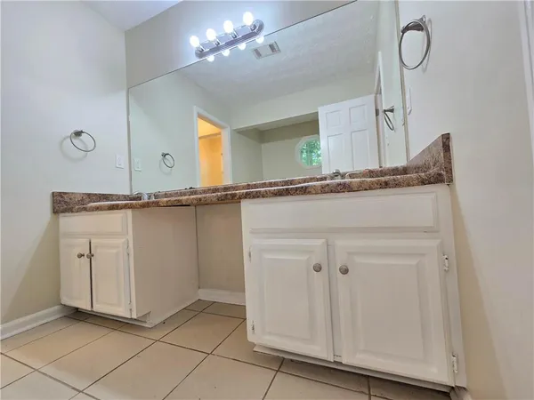 a view of a kitchen with cabinets and wooden floor