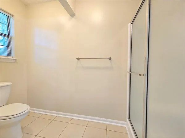 a bathroom with a toilet and shower