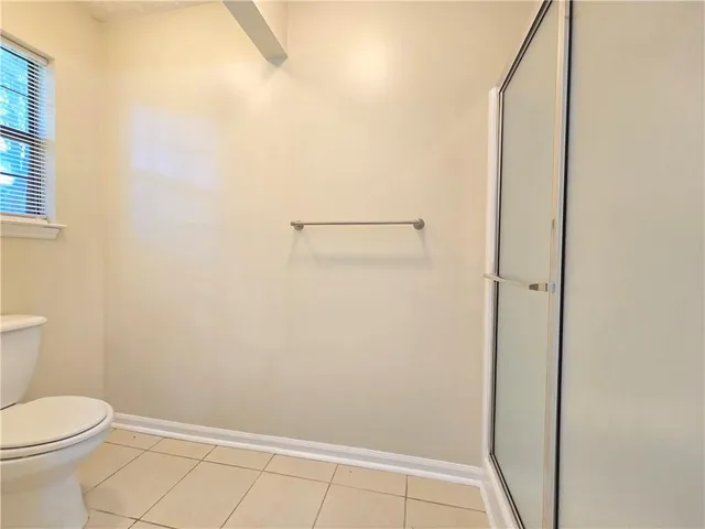 a bathroom with a toilet and shower
