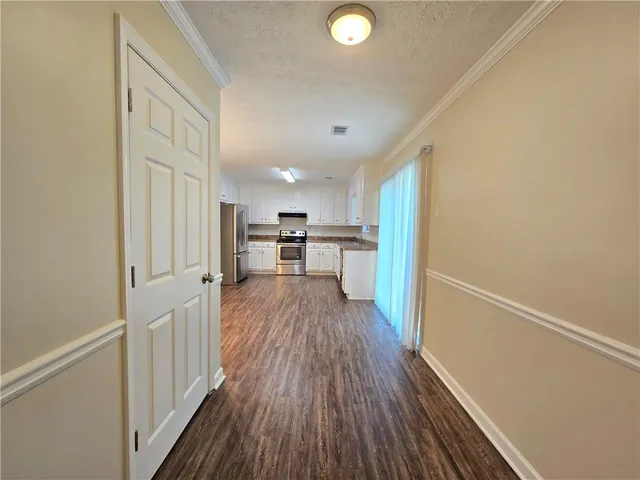 a view of a hallway with wooden floor