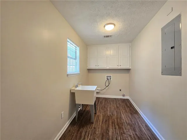 a view of a room with wooden floor cabinets and a window