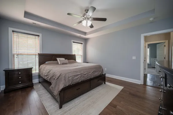 a bedroom with a large bed and a tv