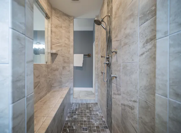 a bathroom with a shower and a mirror