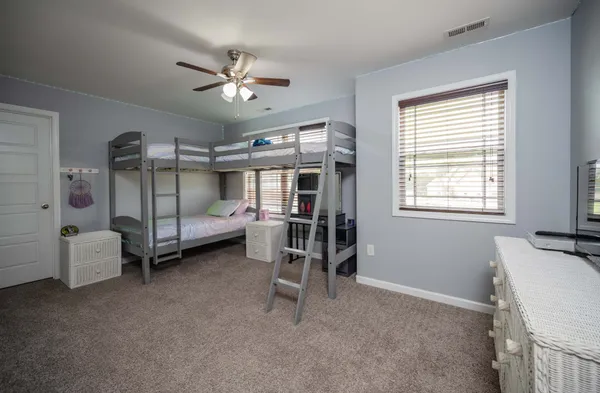 a bedroom with furniture and a window