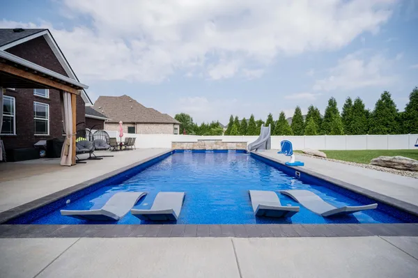a view of swimming pool with seating space and hardwood floor