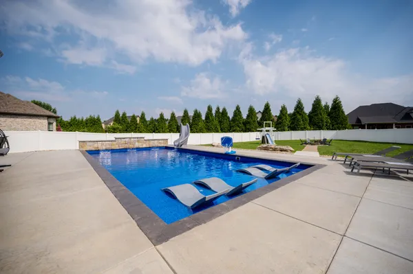 swimming pool view with lake view and mountain view in back
