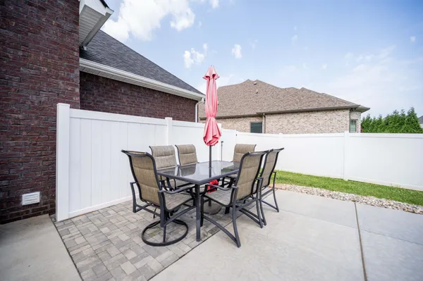a view of a patio with a table and chairs