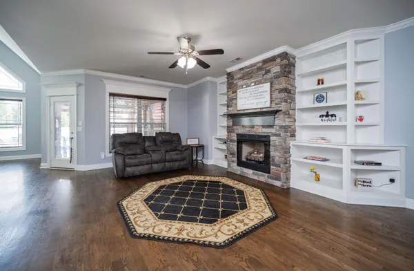 a living room with furniture and a fireplace