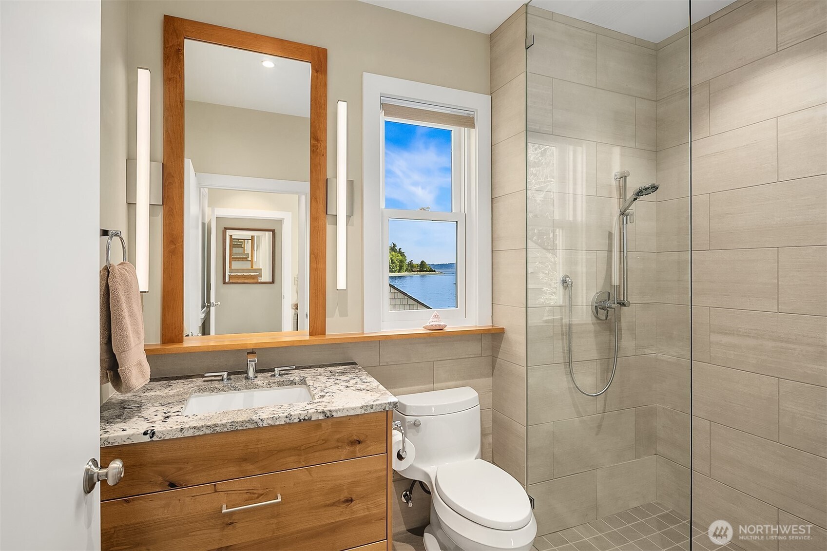 7161 Beach Drive Southwest Seattle, WA 98136 - Photo 21 of 40 a bathroom with a granite countertop sink toilet a mirror and shower