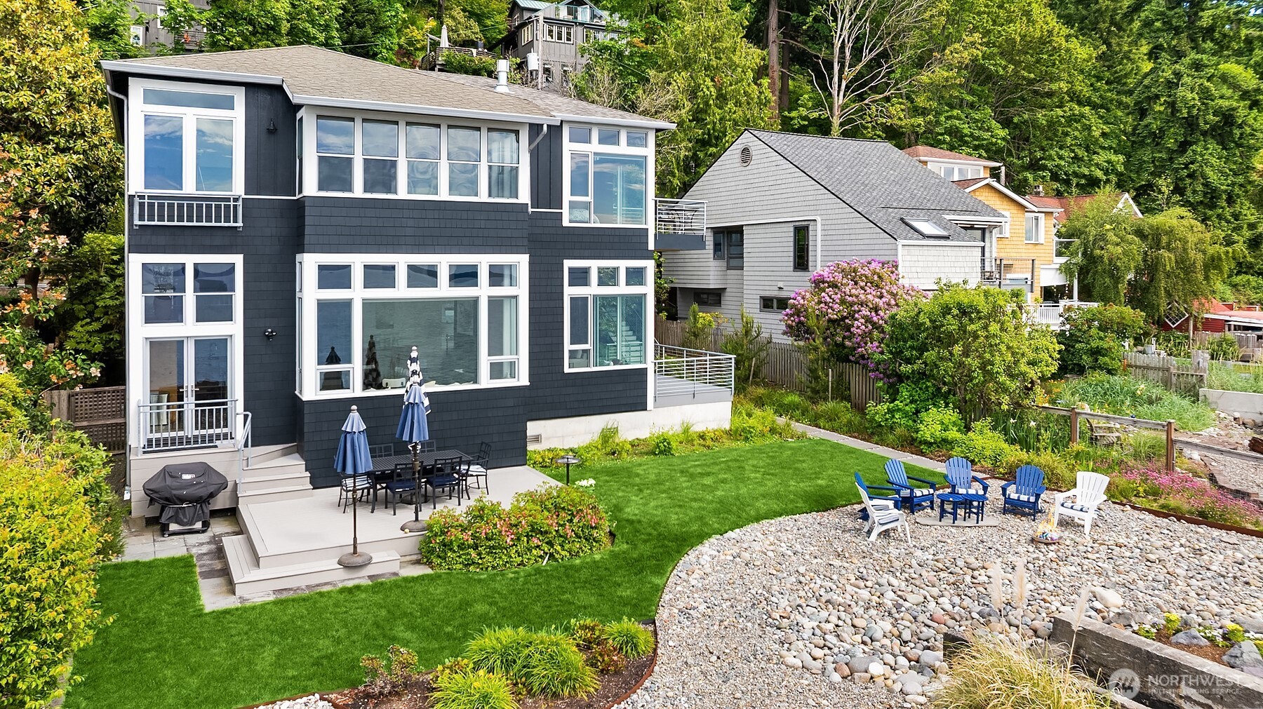 7161 Beach Drive Southwest Seattle, WA 98136 - Photo 3 of 40 a front view of a house with a yard and potted plants
