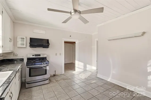 a kitchen with granite countertop a stove and a refrigerator