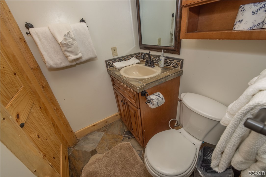 42324 Eagle Ridge Big Bear Lake, CA 92315 - Photo 31 of 50 a bathroom with a toilet sink and mirror