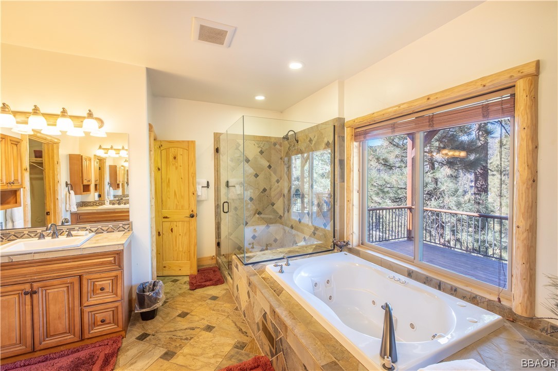 42324 Eagle Ridge Big Bear Lake, CA 92315 - Photo 38 of 50 a spacious bathroom with a tub sink and shower
