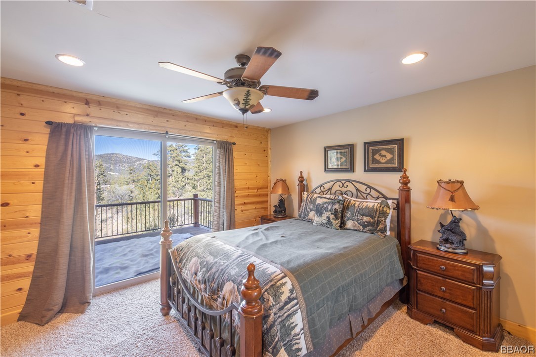 42324 Eagle Ridge Big Bear Lake, CA 92315 - Photo 43 of 50 a bedroom with a large bed and a chandelier