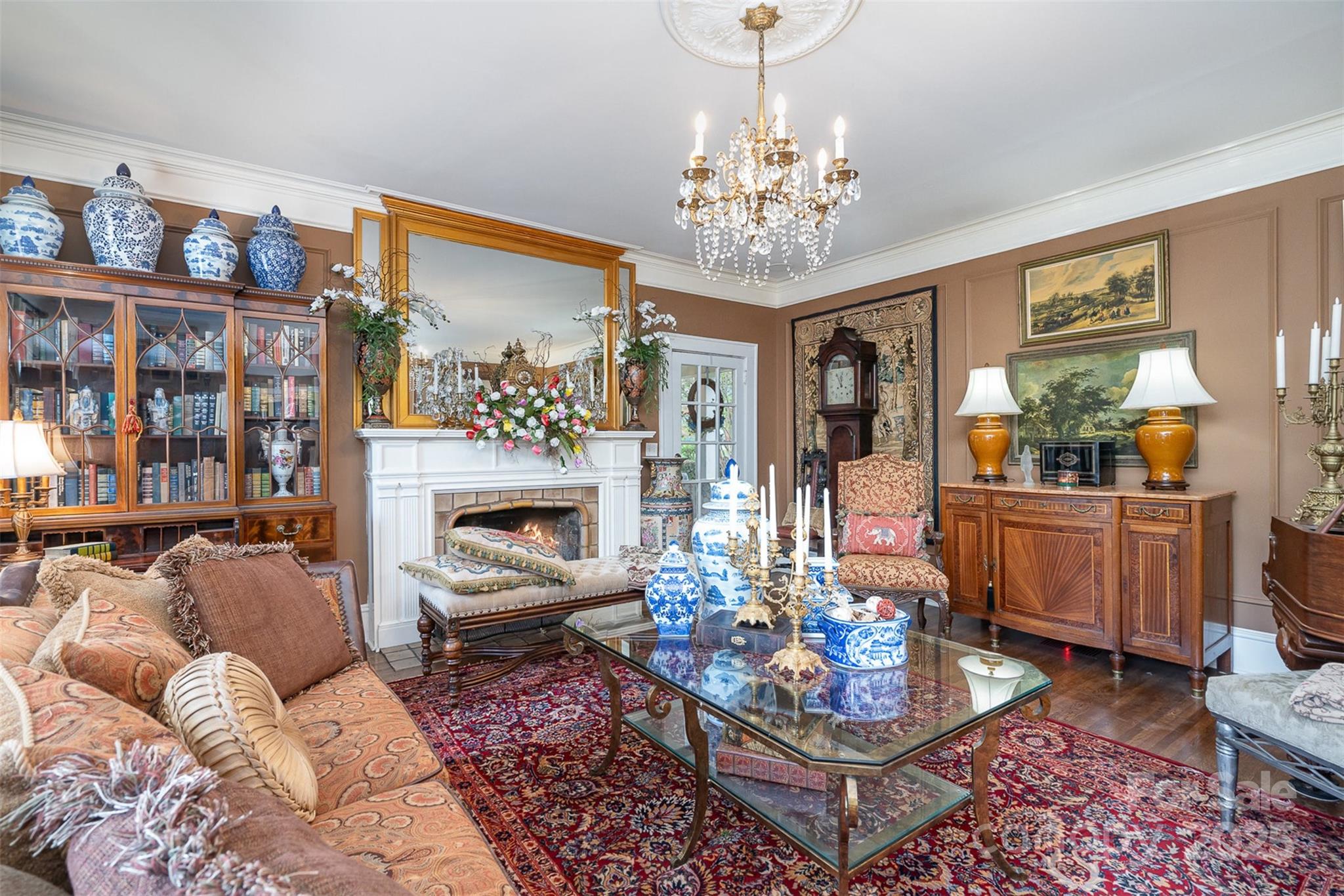 1313 South York Road Gastonia, NC 28052 - Photo 11 of 45 a living room with furniture a rug and a chandelier
