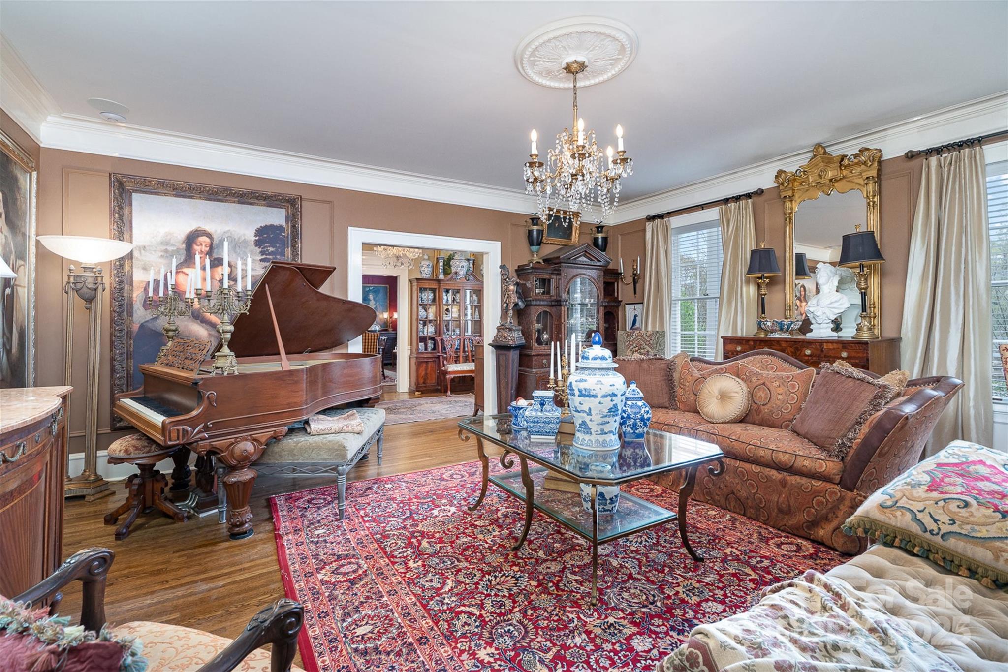 1313 South York Road Gastonia, NC 28052 - Photo 12 of 45 a living room with furniture a chandelier and a rug