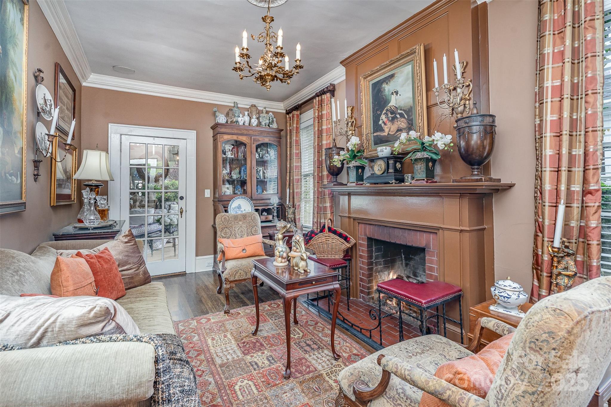 1313 South York Road Gastonia, NC 28052 - Photo 19 of 45 a living room with furniture a chandelier and a fireplace