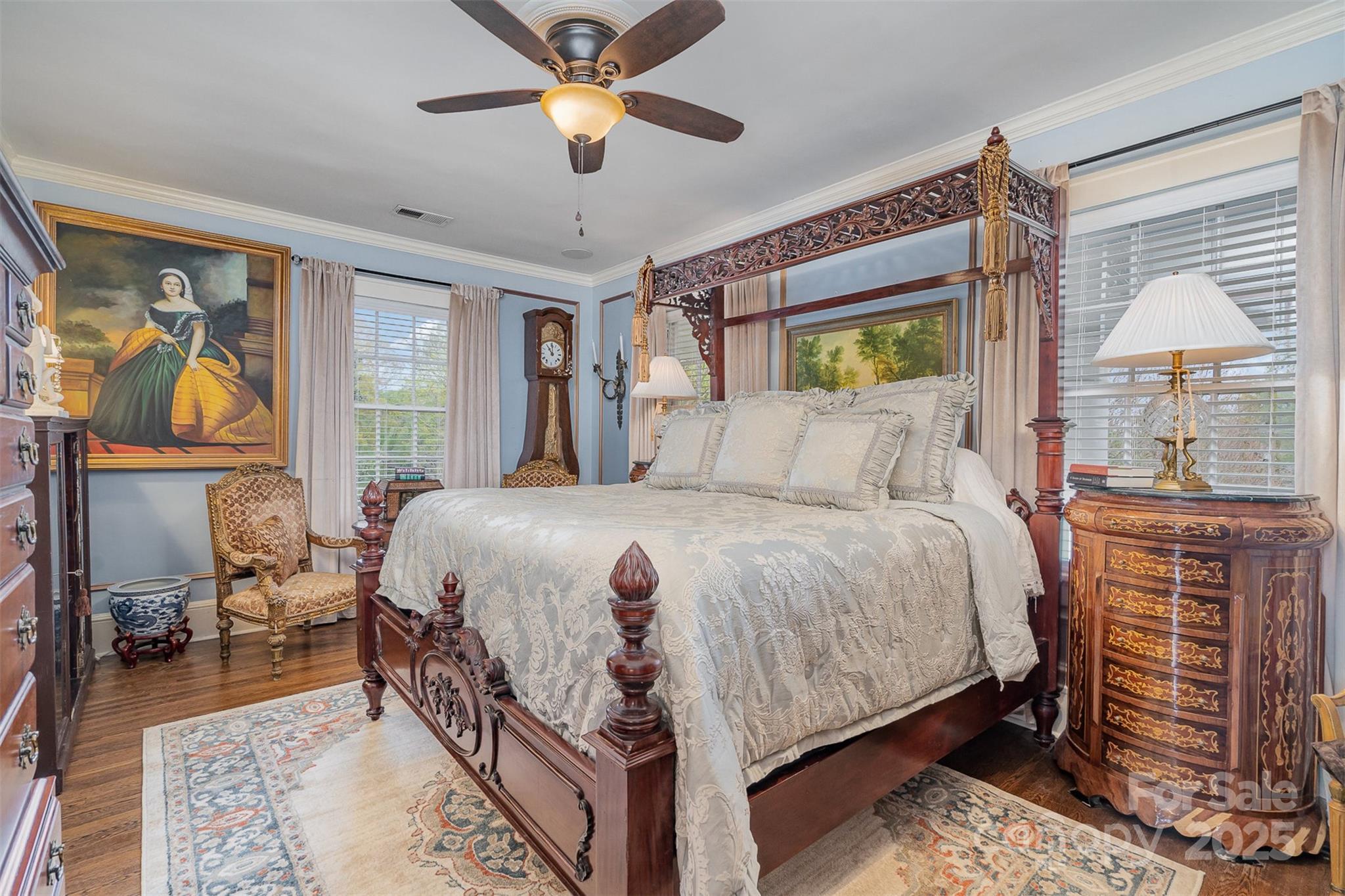 1313 South York Road Gastonia, NC 28052 - Photo 25 of 45 a bedroom with a bed and a chandelier