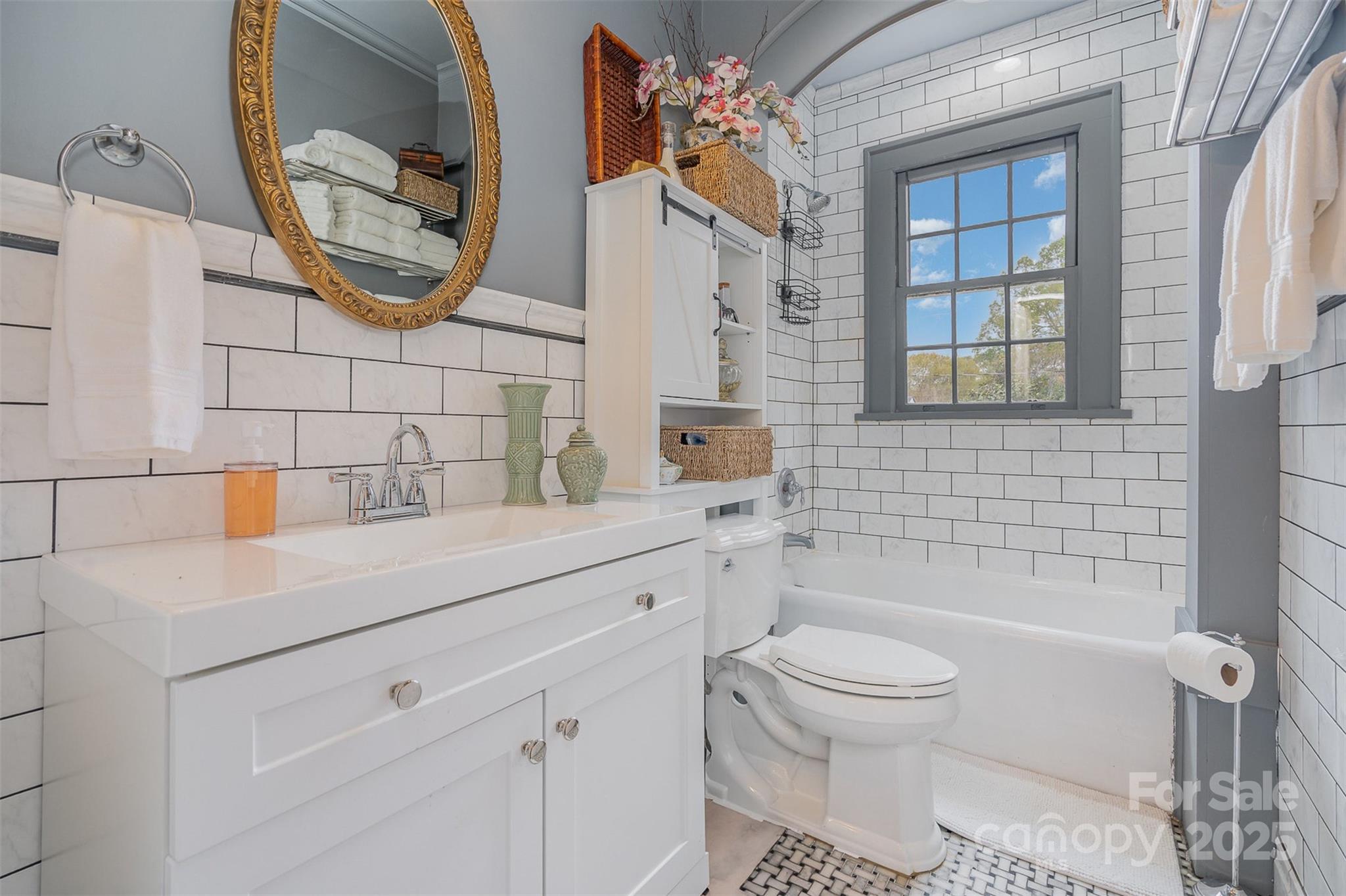 1313 South York Road Gastonia, NC 28052 - Photo 26 of 45 a bathroom with a sink a toilet and a mirror