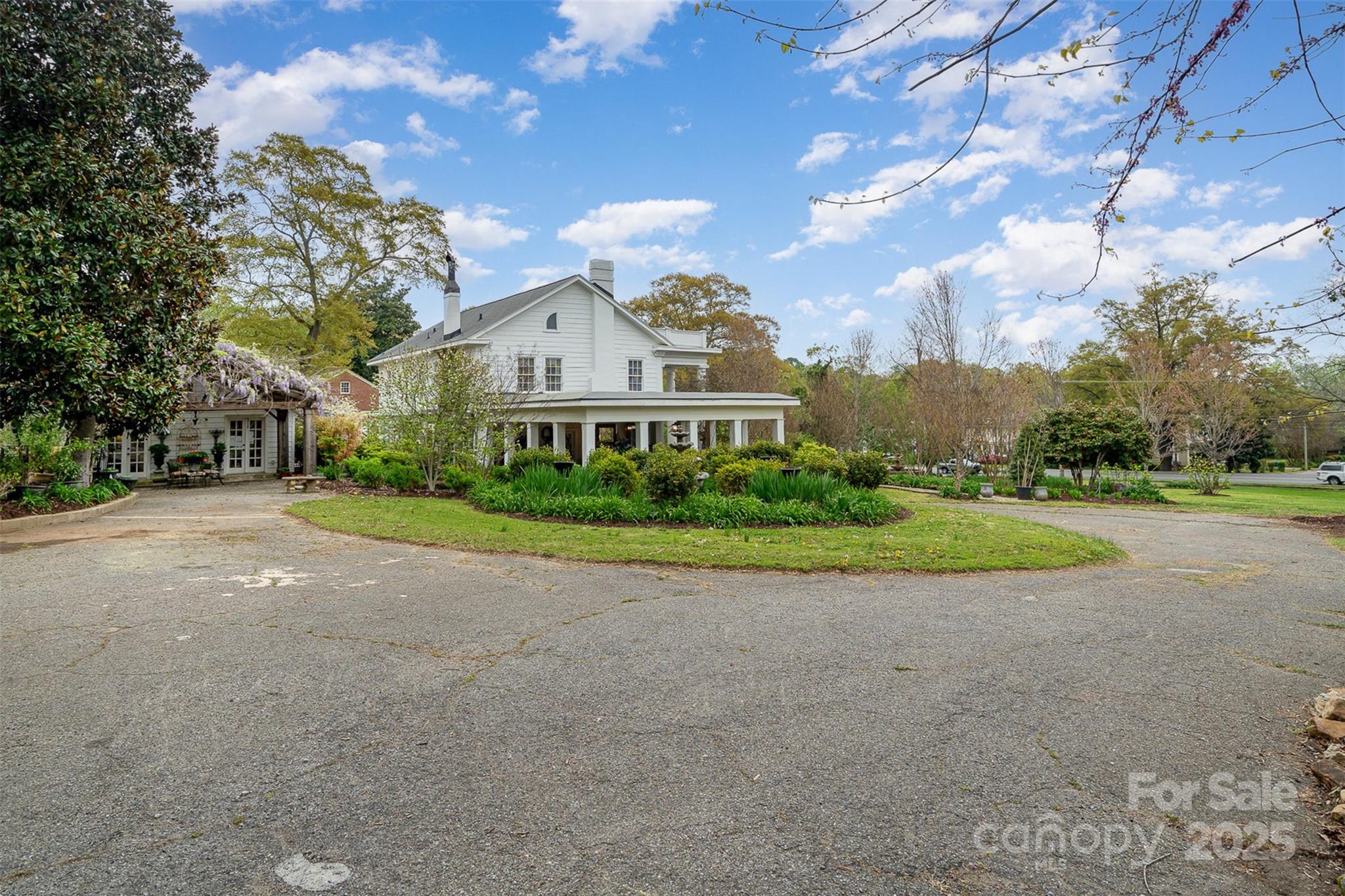 1313 South York Road Gastonia, NC 28052 - Photo 3 of 45 a view of a house with a big yard plants and large trees