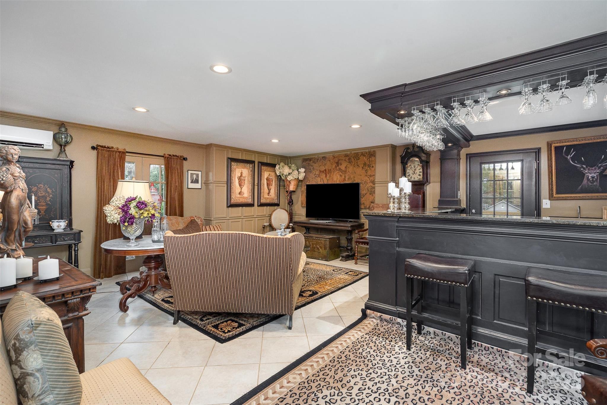 1313 South York Road Gastonia, NC 28052 - Photo 32 of 45 a living room with furniture and a flat screen tv