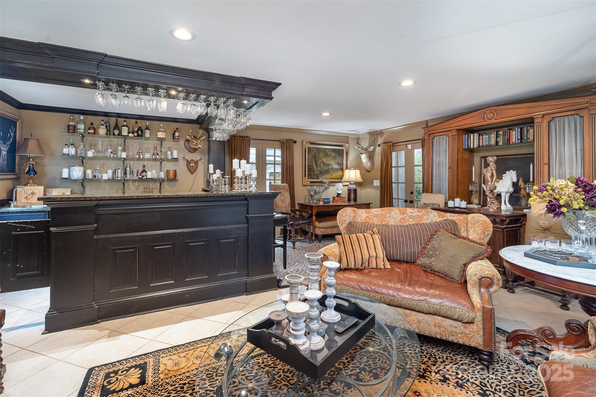 1313 South York Road Gastonia, NC 28052 - Photo 33 of 45 a living room with furniture a rug and a chandelier