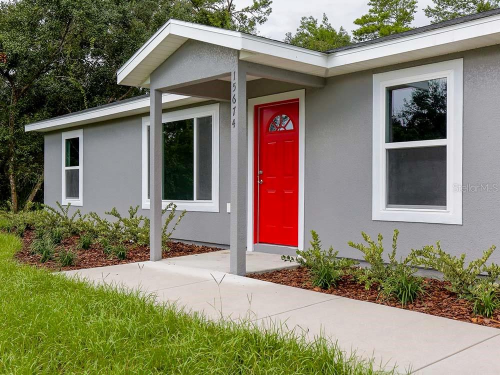17122 Southwest 20th Ct Road Ocala, FL 34473 - Photo 1 of 1 a front view of a house with yard