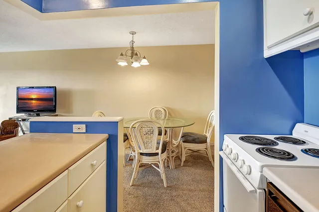 a kitchen that has a stove and a table