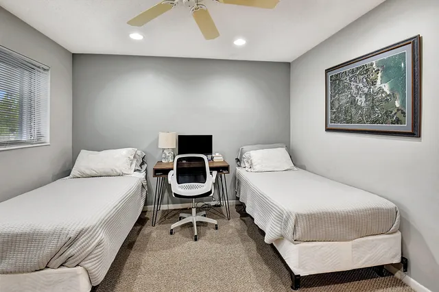 a bedroom with a bed and a chair