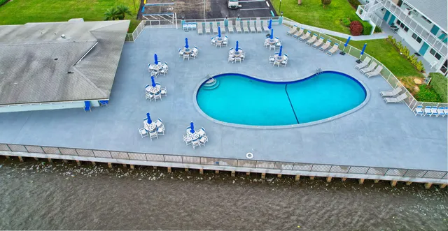 a view of a swimming pool and outdoor seating