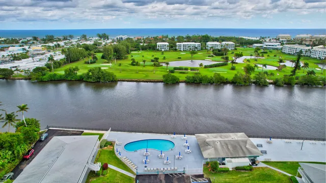 a patio with a table and chairs and potted plants