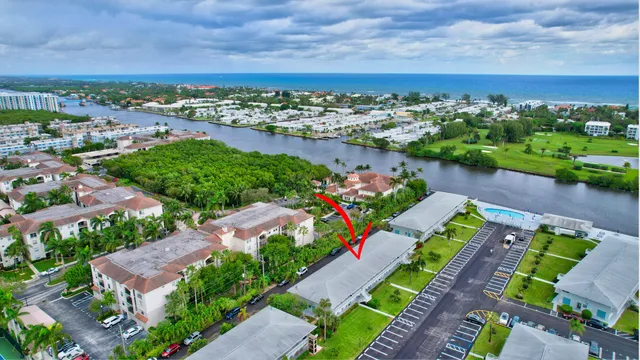 an aerial view of a house with a garden and lake view