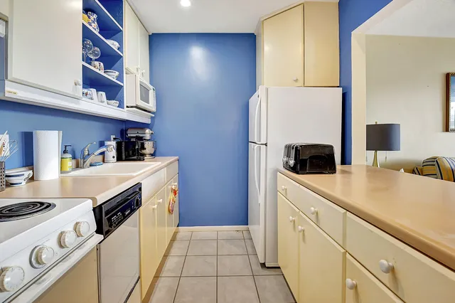a kitchen with a stove a refrigerator and a sink