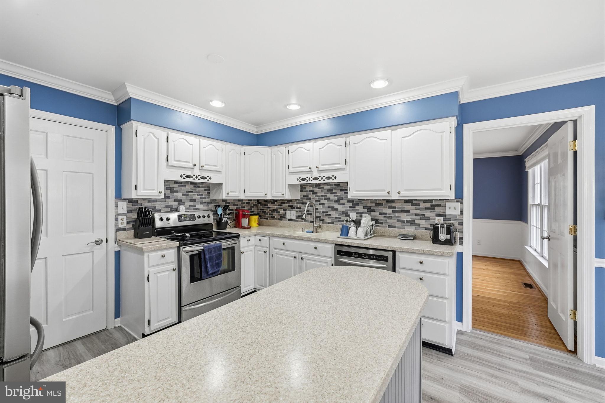 140 Hoile Lane Huntingtown, MD 20639 - Photo 11 of 44 a kitchen with a sink stove and refrigerator