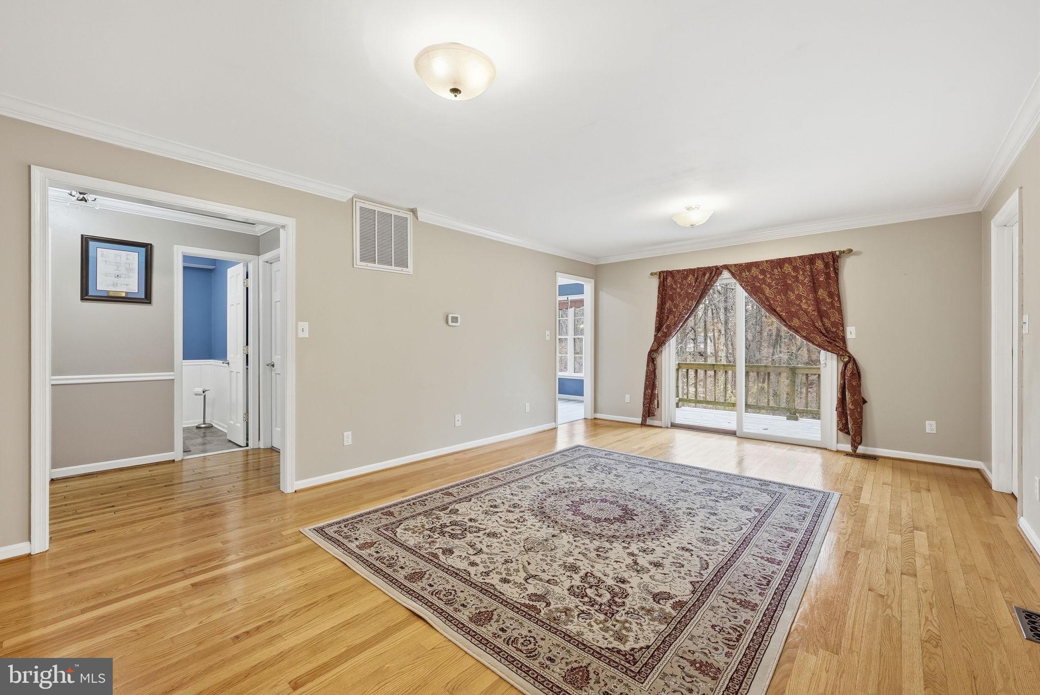 140 Hoile Lane Huntingtown, MD 20639 - Photo 15 of 44 an empty room with wooden floor and windows