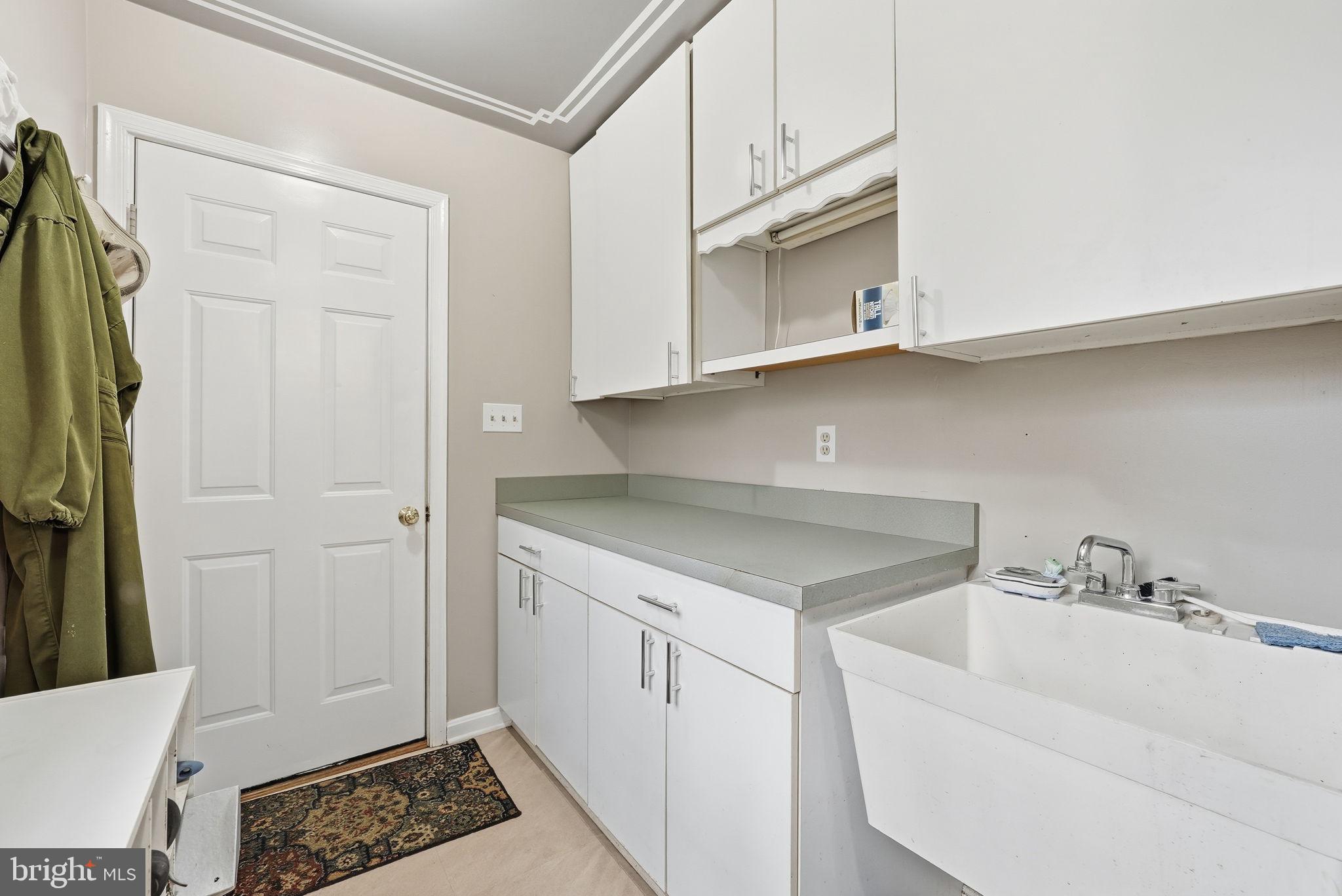 140 Hoile Lane Huntingtown, MD 20639 - Photo 16 of 44 a kitchen with white cabinets and a sink