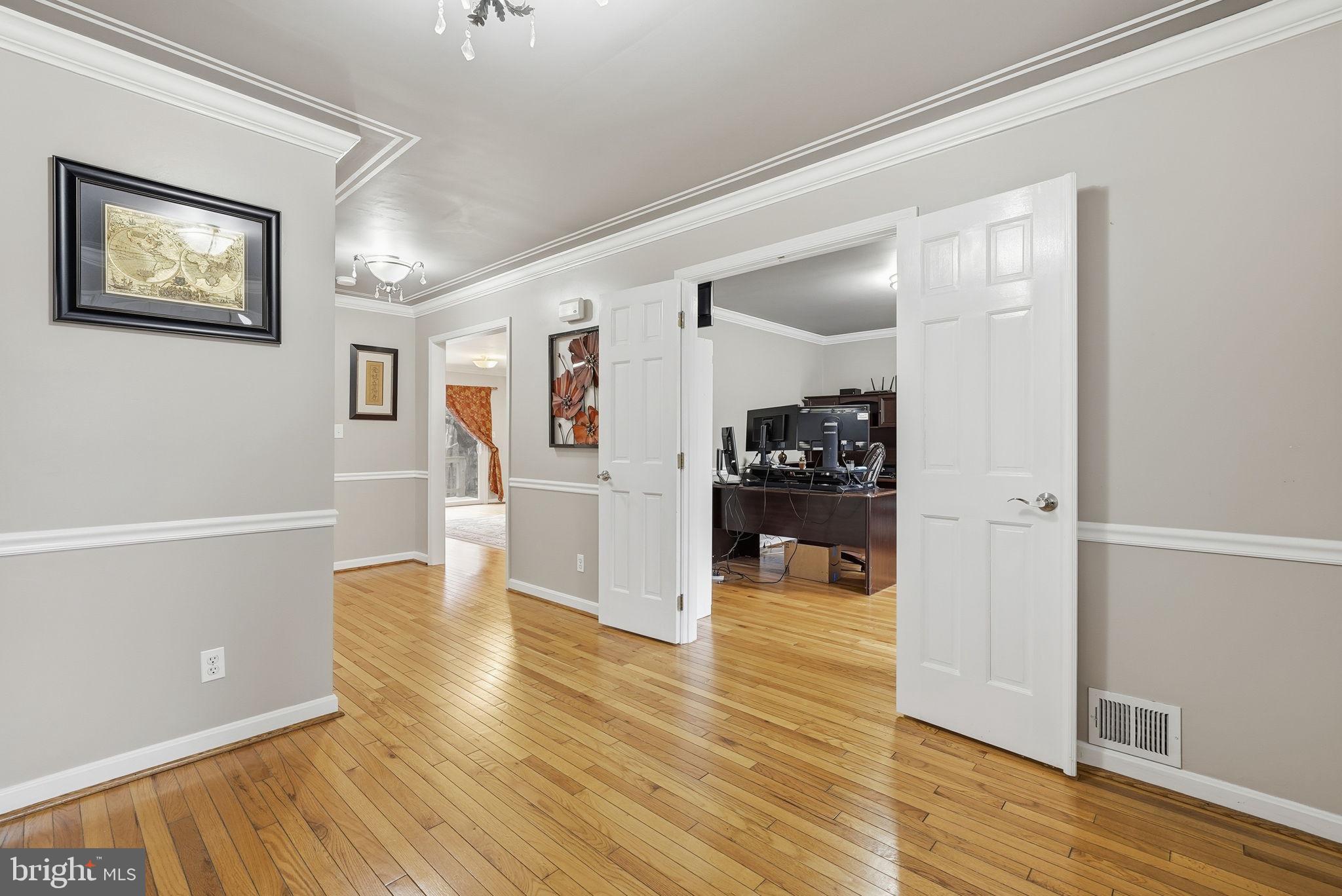 140 Hoile Lane Huntingtown, MD 20639 - Photo 17 of 44 a view of a hallway with wooden floor and a living room
