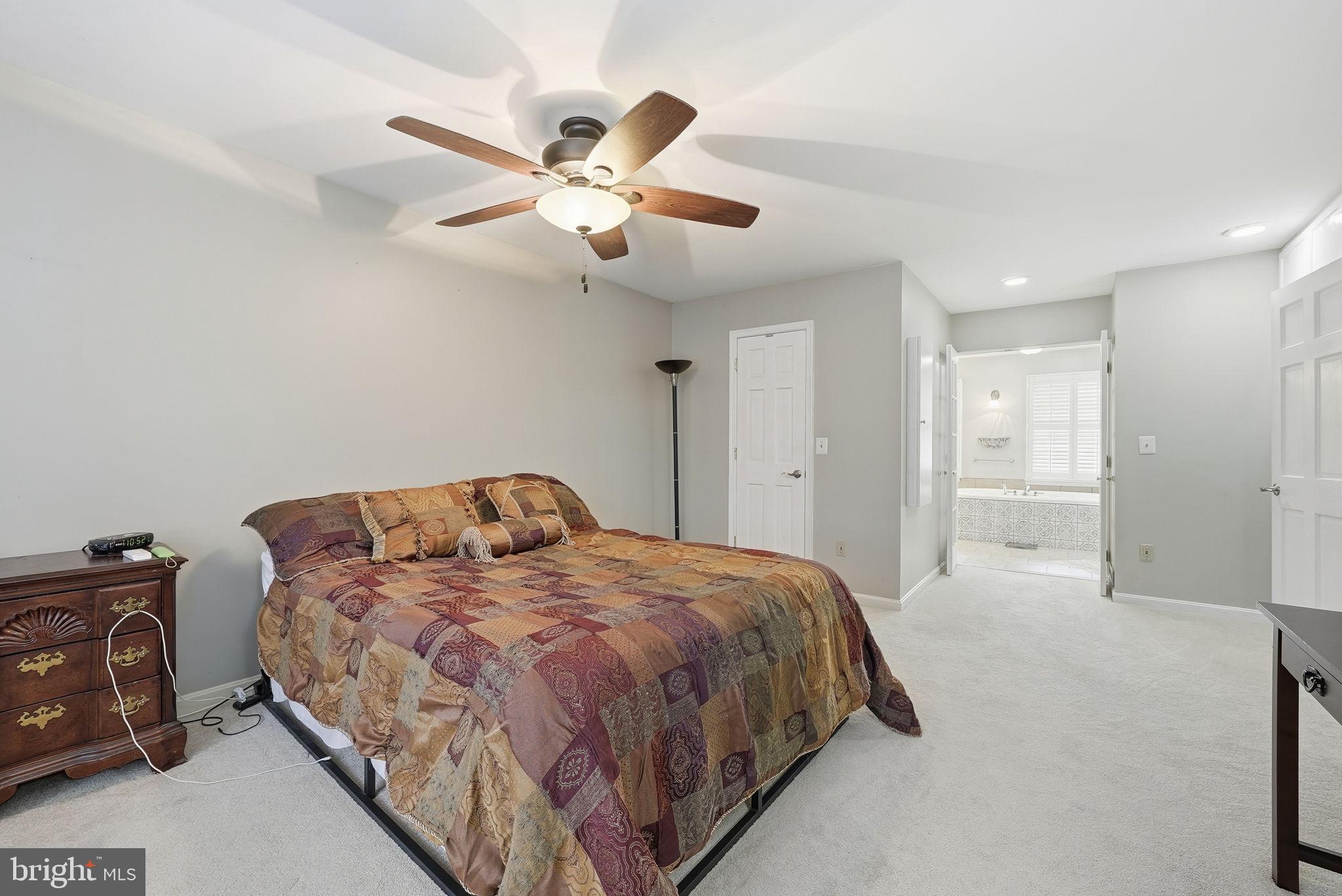 140 Hoile Lane Huntingtown, MD 20639 - Photo 21 of 44 a bedroom with a large bed and a chandelier