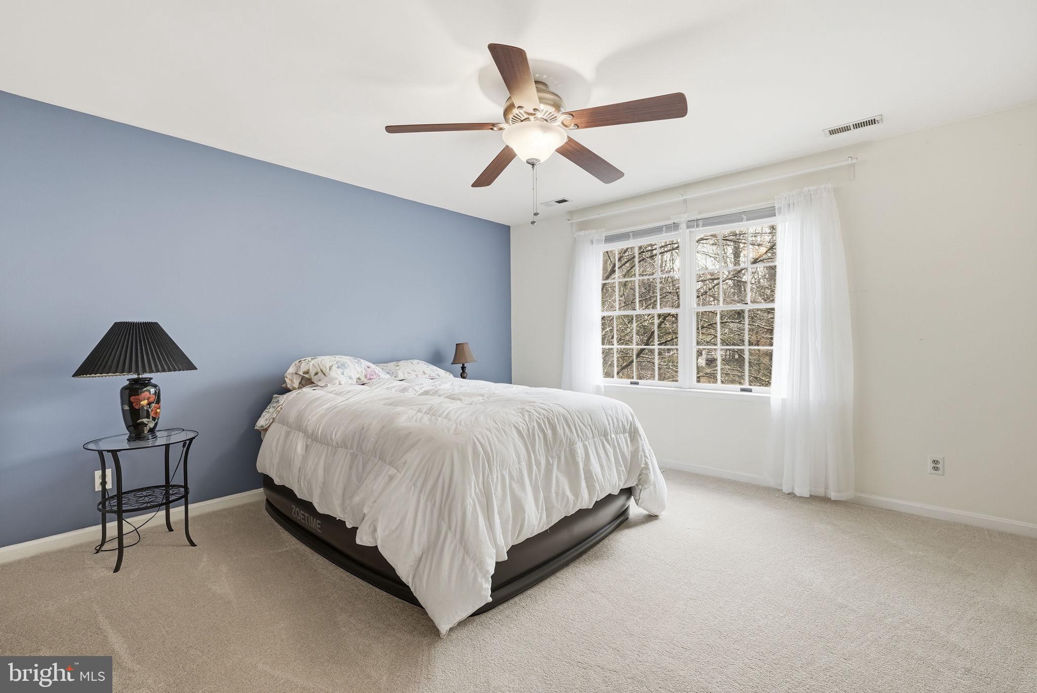 140 Hoile Lane Huntingtown, MD 20639 - Photo 27 of 44 a spacious bedroom with a bed and a window