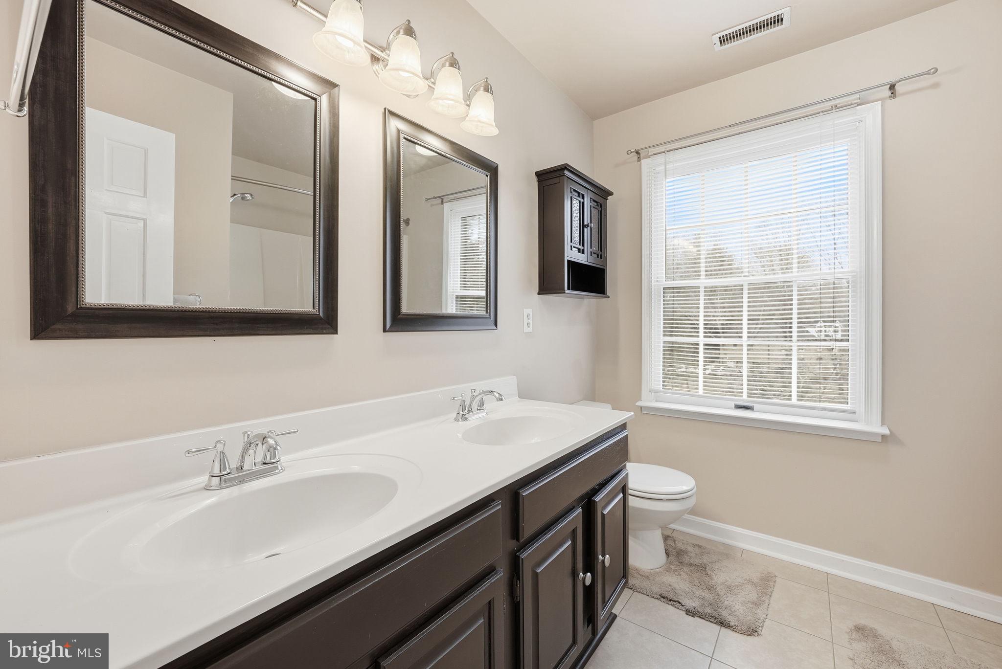 140 Hoile Lane Huntingtown, MD 20639 - Photo 32 of 44 a bathroom with a sink and a mirror