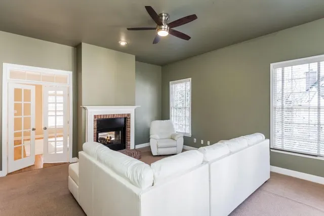 a living room with a fireplace and a chandelier
