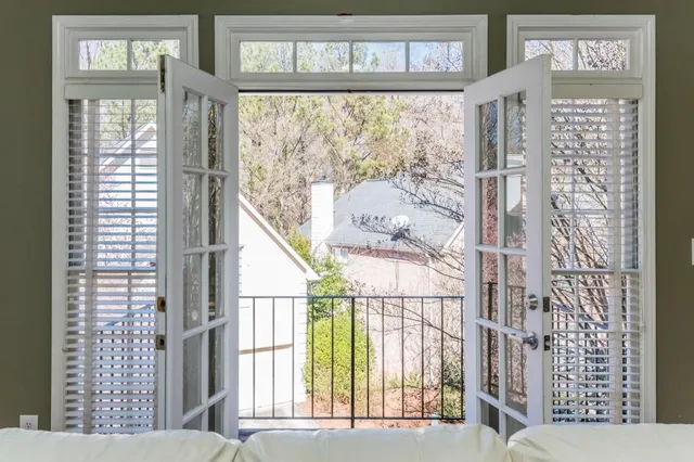 a kitchen with a stove a sink a kitchen island with chairs and wooden floor