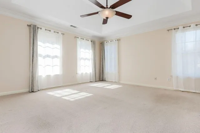 a spacious bathroom with a granite countertop sink a mirror a bathtub and next to a window