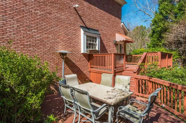 a view of backyard with deck and wooden floor