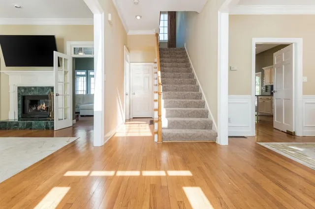 a view of a livingroom with wooden floor and a fireplace