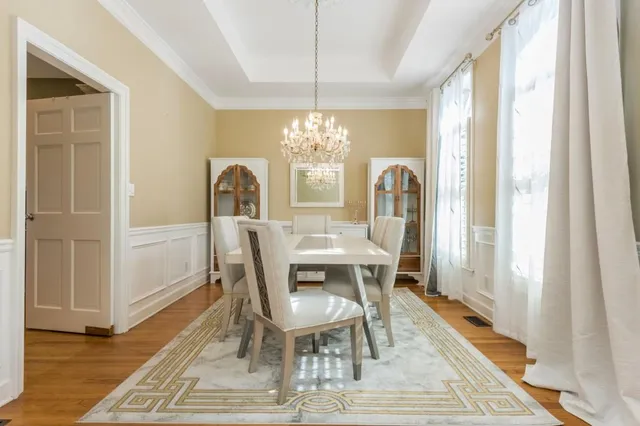 a view of a dining room with furniture window and wooden floor