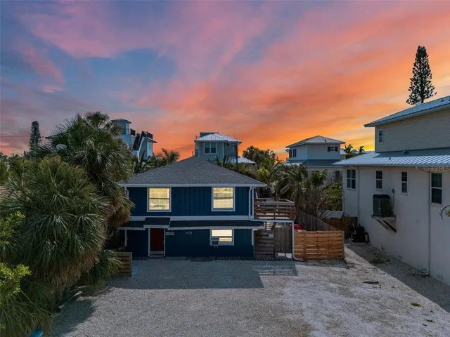 a view of a house with a backyard and a patio